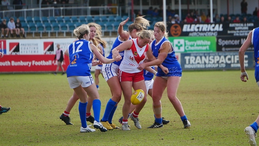 A group of girls playing a game of football