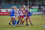 A group of girls playing a game of football
