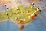 A generic undated stock photo showing a map of Australia with heaps of pins stuck in it.