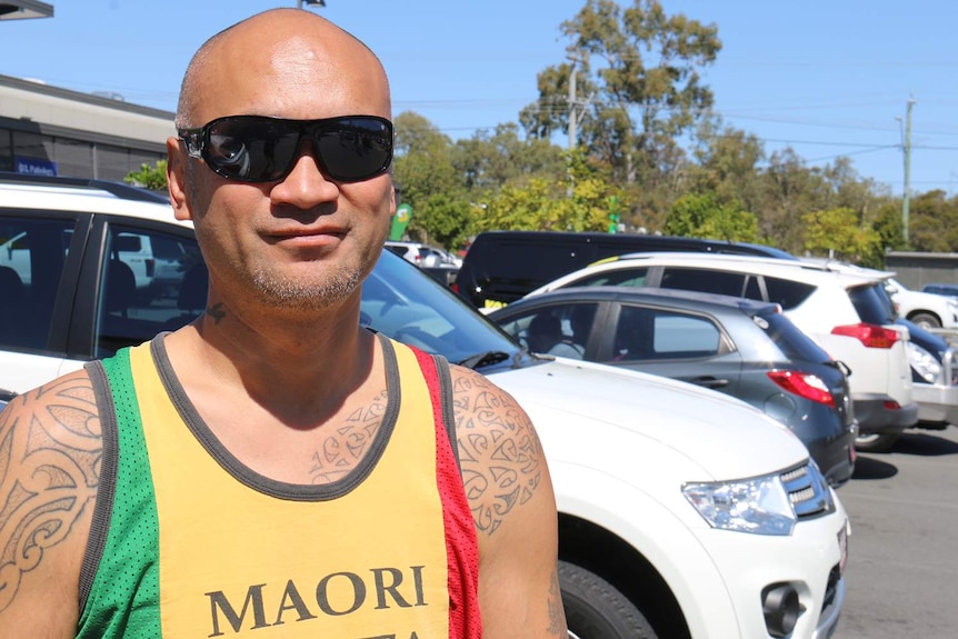 Parent Cameron Dudley, wearing sunglasses, speaks to ABC in a carpark.