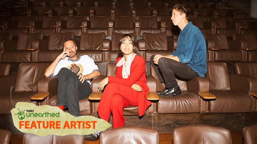 The three members of Telenova sit on brown leather chairs. One wears a white shirt, one a red suit and the other a blue shirt.