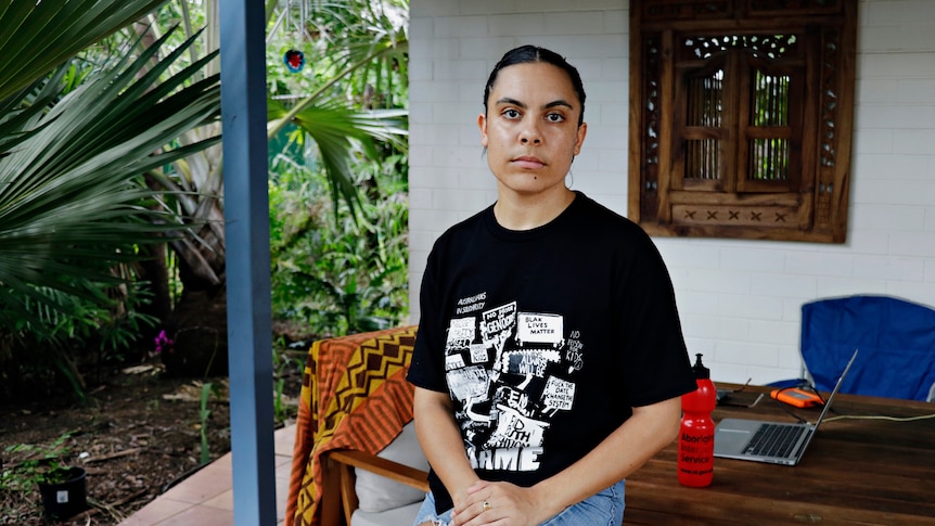 Law student Mililma May sits at her house in Darwin.