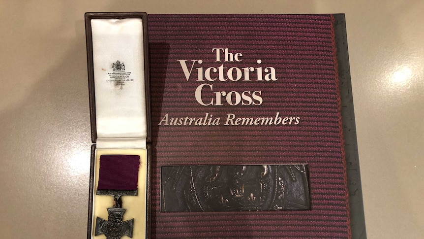 book on the victoria cross with a victoria cross medal sitting on it