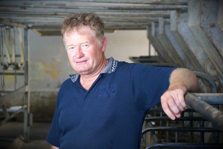 Dairy farmer Craig Tate leans on machinery at his property.