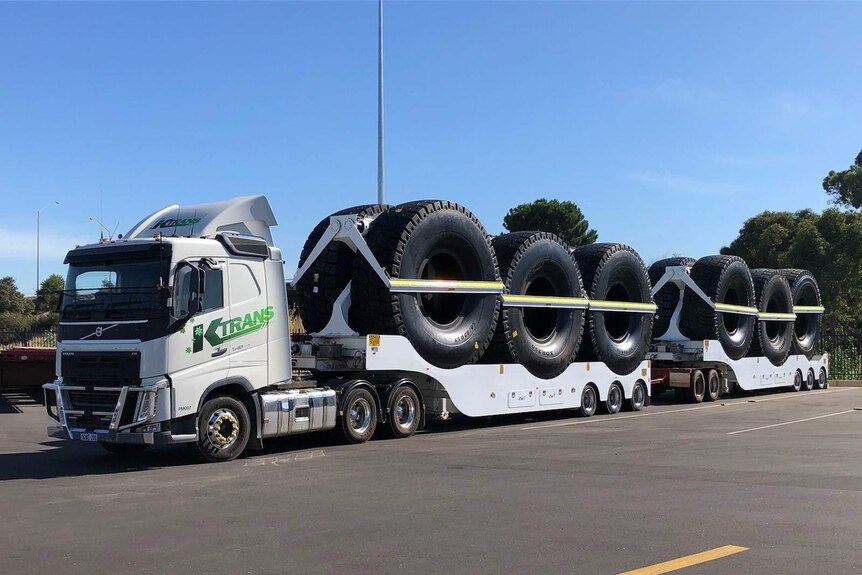 A KTrans road train carrying large tyres.
