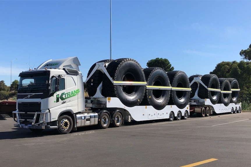 A KTrans road train carrying large tyres.