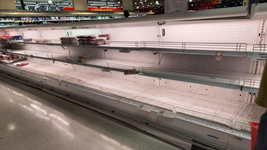 an empty supermarket with bare shelves