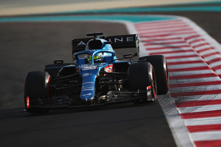 Australia's Oscar Piastri drives a Formula 1 car in testing, with his back left wheel just off the track.