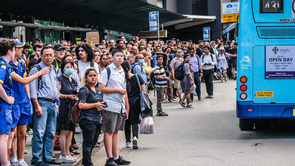 Hundreds of people waiting for a bus
