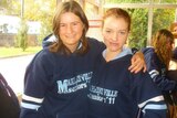 Two teenaged girls stand arm in arm with "Marryatville Seniors" written on their school uniforms.
