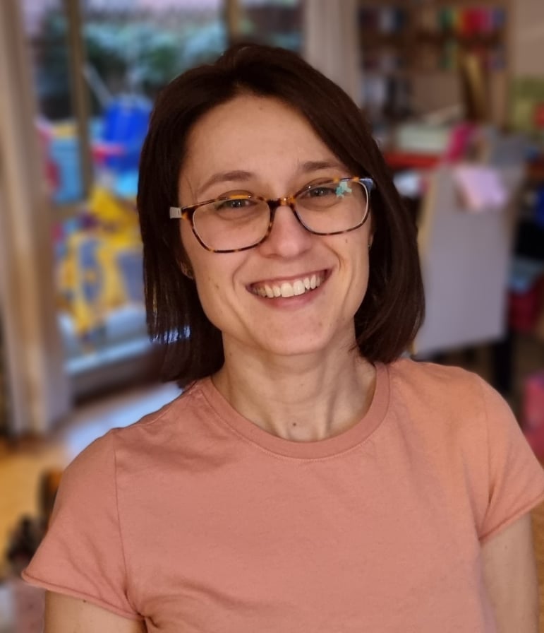 A smiling woman with dark hair.