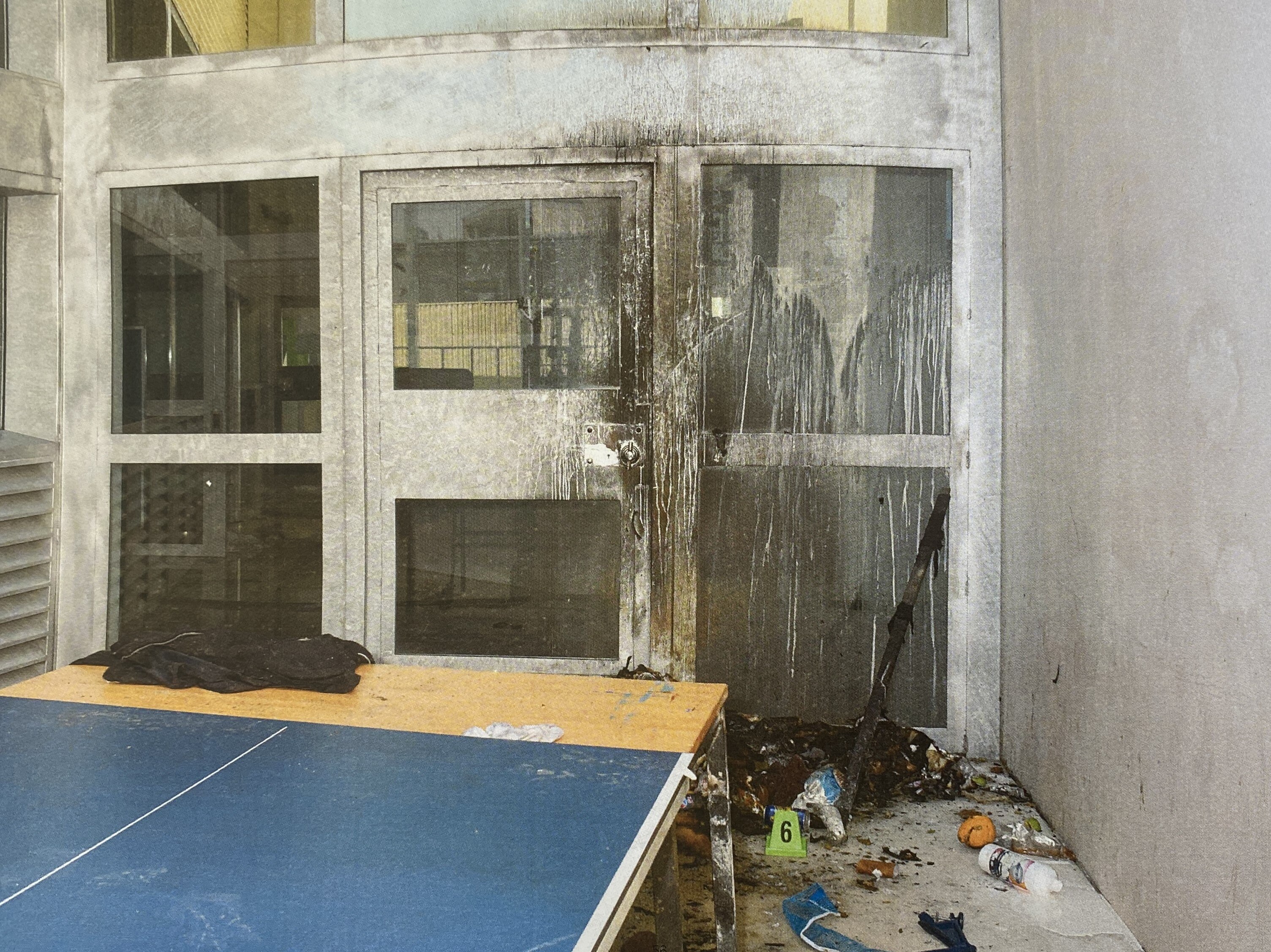 Fire damage to a door inside a prison.