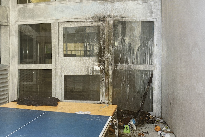 Fire damage to a door inside a prison.