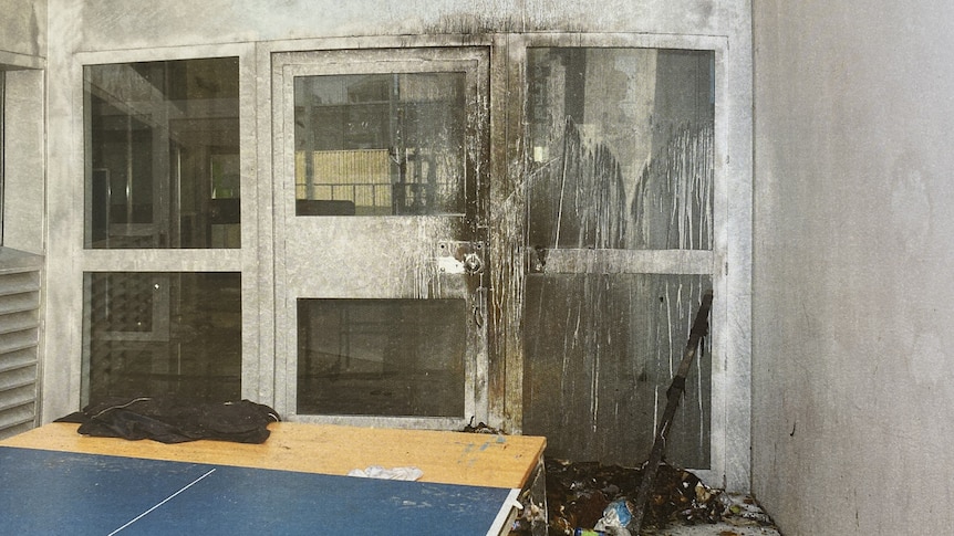 Fire damage to a door inside a prison.