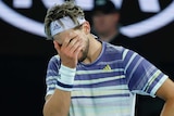 Dominic Thiem puts his hand to his face during the Australian Open final against Novak DJokovic.