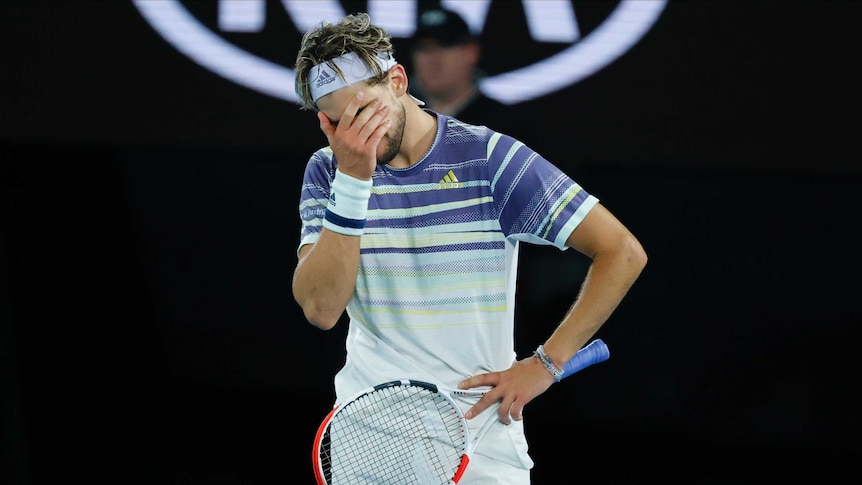 Dominic Thiem puts his hand to his face during the Australian Open final against Novak DJokovic.