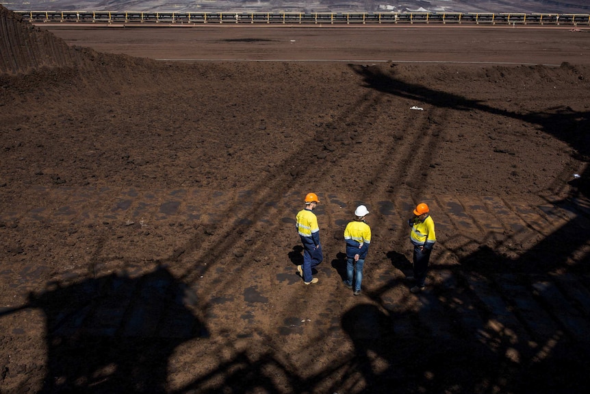 Workers at Hazelwood framed in the shadows of steel cables.