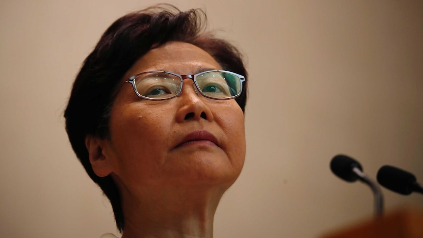 A close photo of Carrie Lam looking up and to her right.