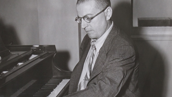 Paul Wittgenstein playing a grand piano with his left arm.