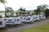 several caravan and RV's lined up at a caravan park