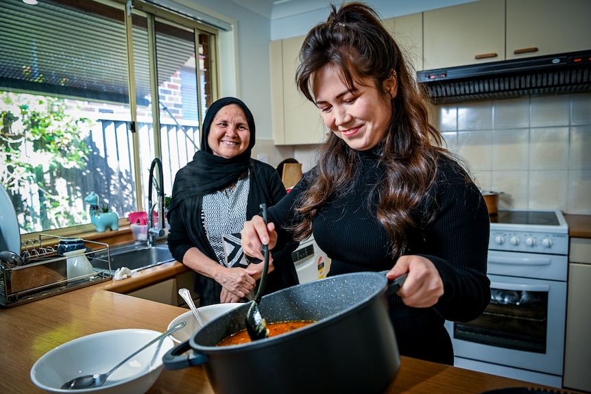 Two women cooking in the kitchen.