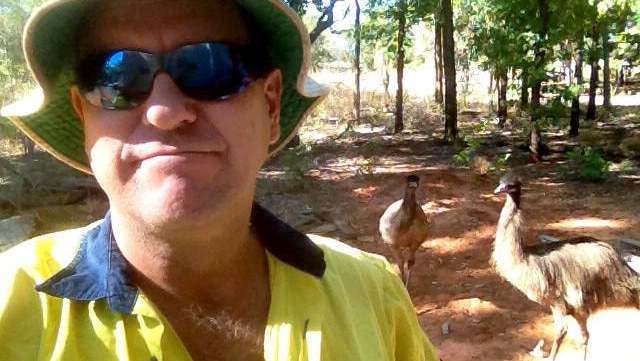 Murry Rhodes with emus Cindy and Mindy at his work site