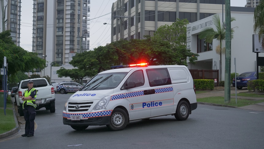 Police vehicles parked across a Gold Coast street