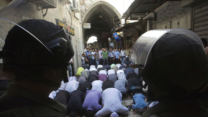 Israeli border police stand guard as Palestinians pray in Jerusalem's Old City