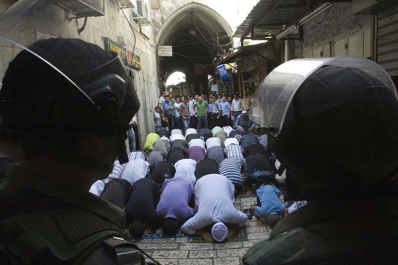 Israeli border police stand guard as Palestinians pray in Jerusalem's Old City