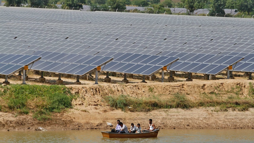 Security personnel patrol the premises of a solar farm at Gunthawada village in the western Indian state of Gujarat.