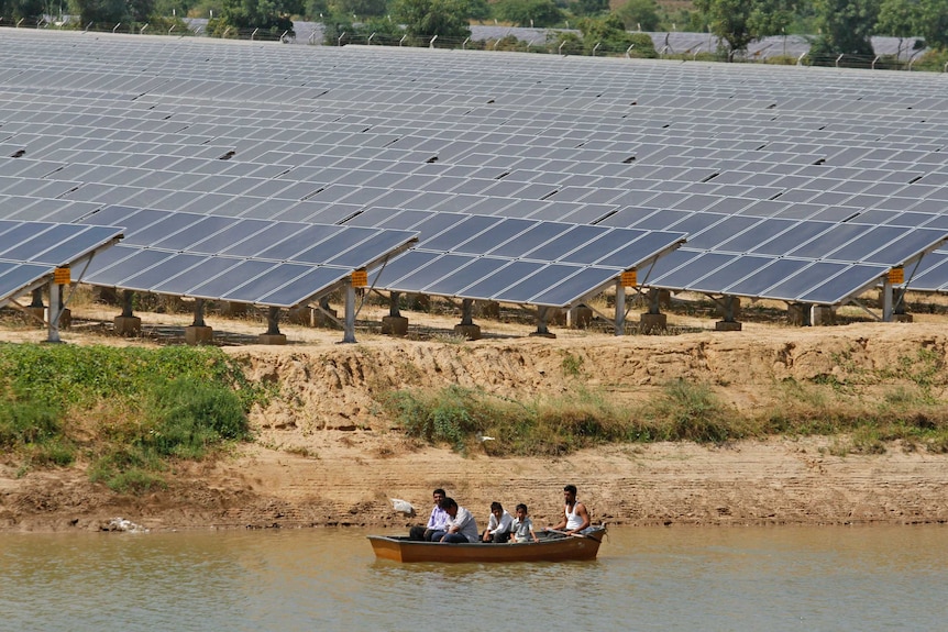 Security personnel patrol the premises of a solar farm at Gunthawada village in the western Indian state of Gujarat.