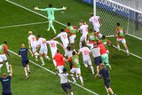 The entire Switzerland team, including substitutes and some staff, chase after the goalkeeper