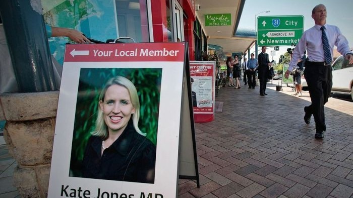 Campbell Newman walks past the office of Kate Jones