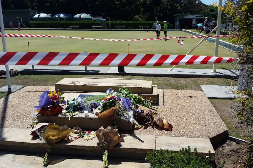 Flowers laid out at the site of the fatal accident near the Black Head Bowling Club.