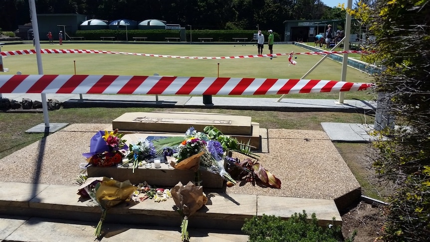 Flowers laid out at the site of the fatal accident near the Black Head Bowling Club.