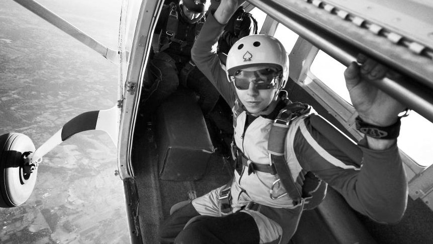 Black and white photo of Brett Dummett about to jump out of a plane