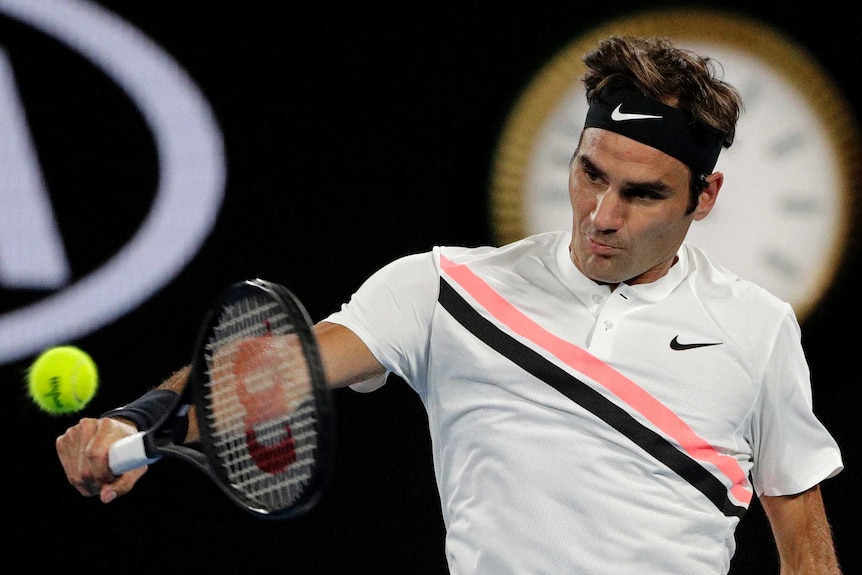 Roger Federer hits a backhand against Marin Cilic