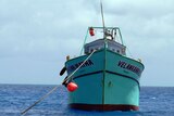 An asylum seeker boat floats in waters near the Cocos Islands