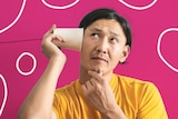 A man holds a paper cup up to his ear and listens, for a story about how to call someone in over sexist or racist remarks.