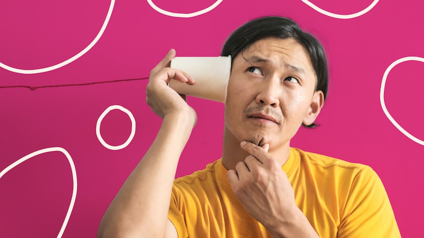 A man holds a paper cup up to his ear and listens, for a story about how to call someone in over sexist or racist remarks.