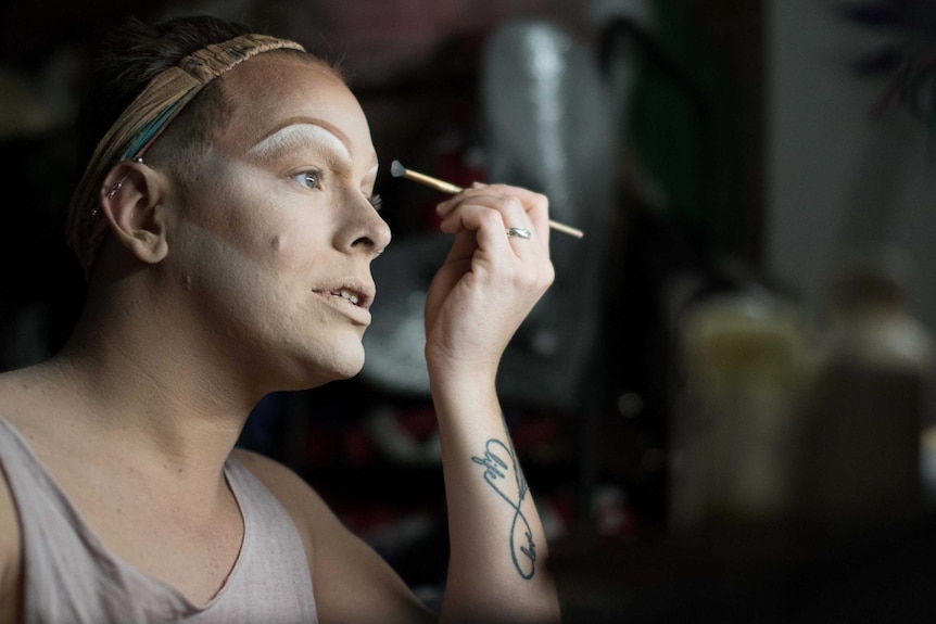 Darwin drag queen Vogue MegaQueen applies her makeup.