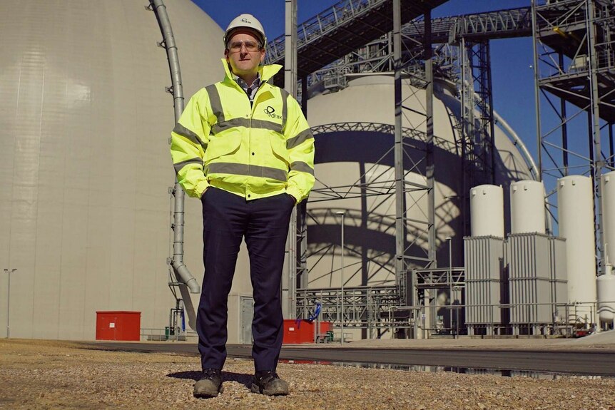Andy Koss standing outside a Drax Power station.