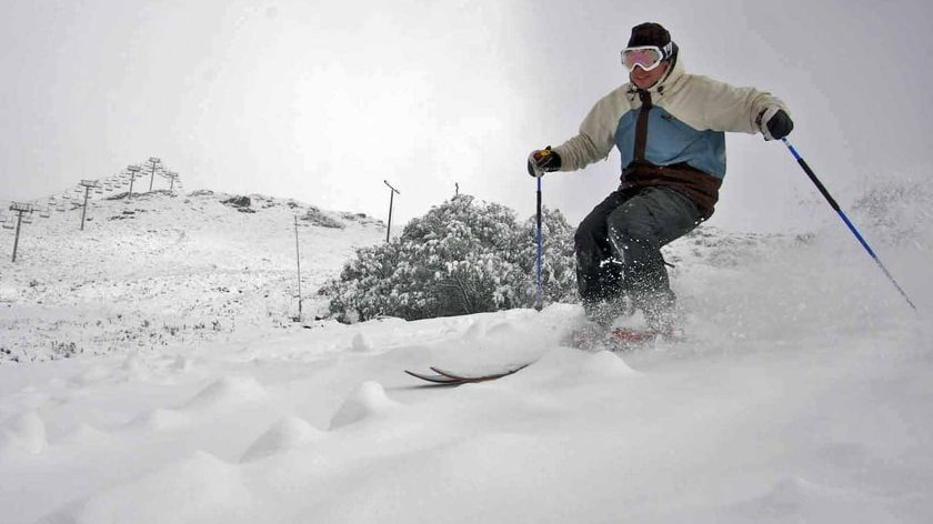 A person skis down a mountain.