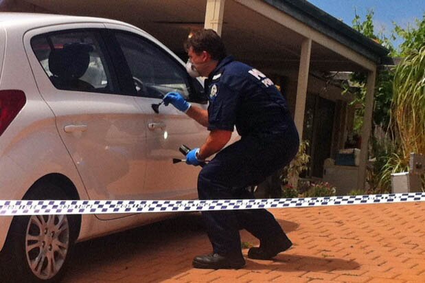 A forensic officer undertakes tests