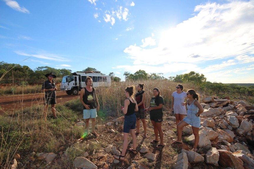 Niall Cooke talking to a group of tourists in the outback