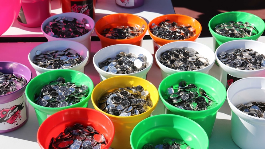 Colourful buckets full of 5 cent pieces