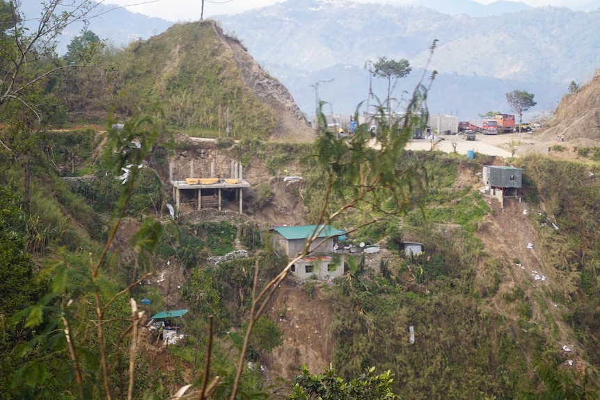Homes on the side of a hill that have been affected by landslides in the Philippines.