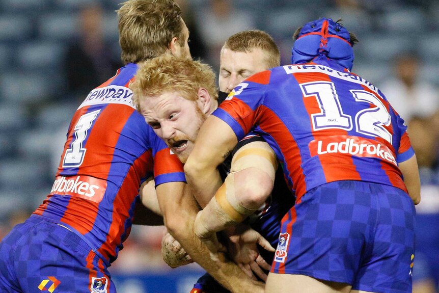 James Graham is wrapped up by the Newcastle Knights defence in 2017