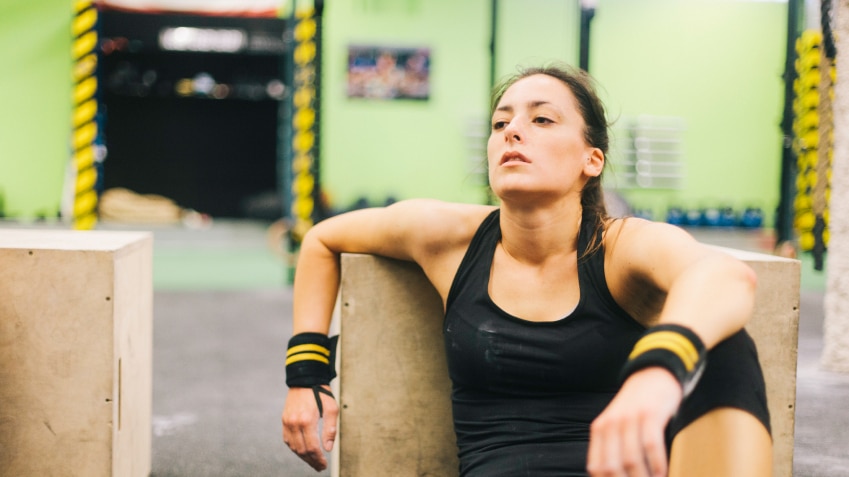 Young woman in intensity training session tired and resting.