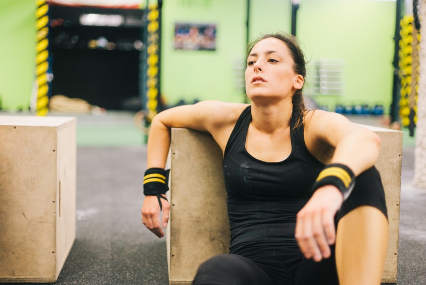 Young woman in intensity training session tired and resting.